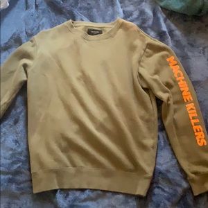 Olive sweatshirt with Orange text on sleeves